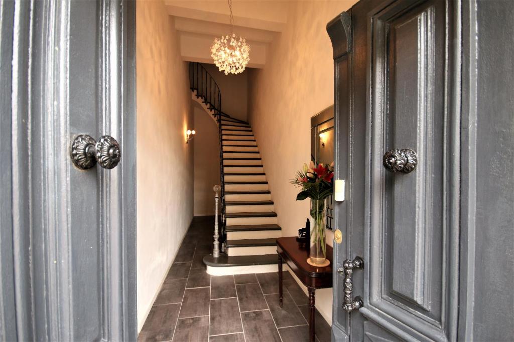 a hallway with a spiral staircase in a house at Maison M Bed and Breakfast in Alignan-du-Vent