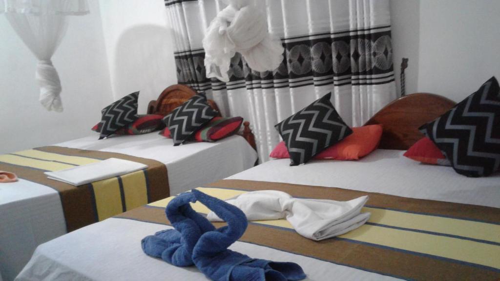 Postel nebo postele na pokoji v ubytování Kalana Homestay