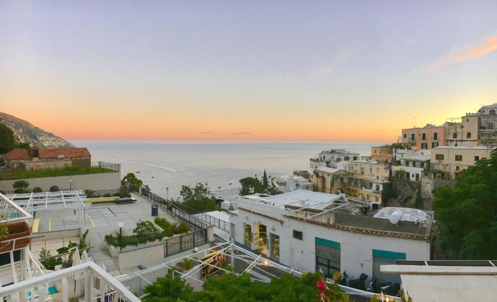 a view of the city of positano at sunset at Hotel Villa Delle Palme in Positano in Positano