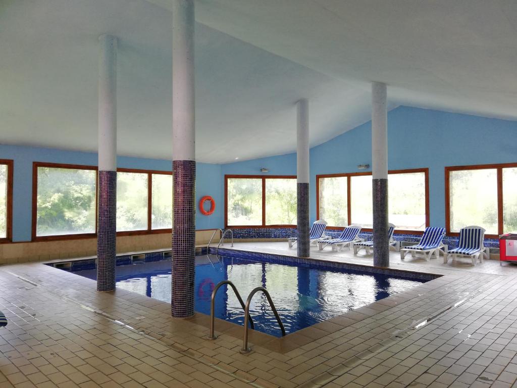 a swimming pool with a lot of windows in it at Hotel Segle XX in El Tarter