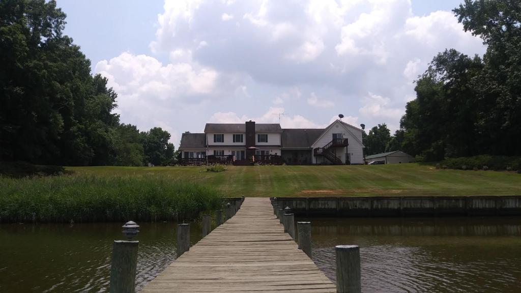 a house on a lake with a wooden dock at Marvels on the creek in East New Market