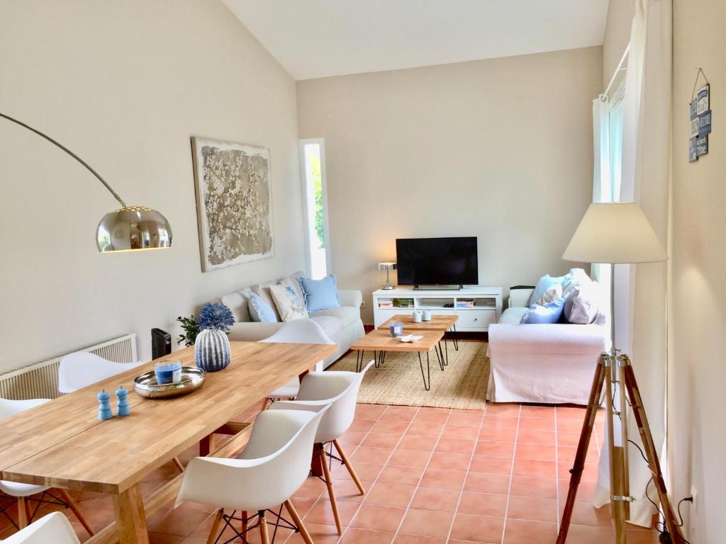 a living room with a table and a couch at Villa BEACH&OCEAN in Son Serra de Marina