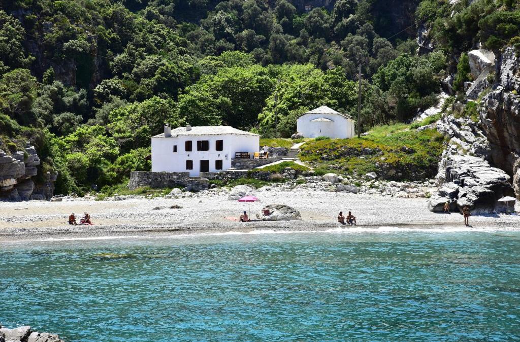 a group of people on a beach near the water at Mylopotamos Beach House in Milopotamos