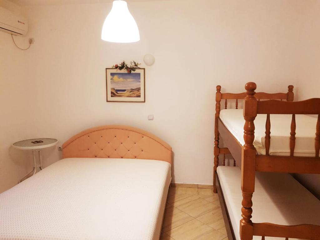 a room with two beds and a bunk bed at Tufio Apartmani Ulcinj in Ulcinj