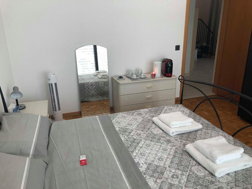 a bedroom with a bed and a dresser and a mirror at Casa Ines in Bellinzona
