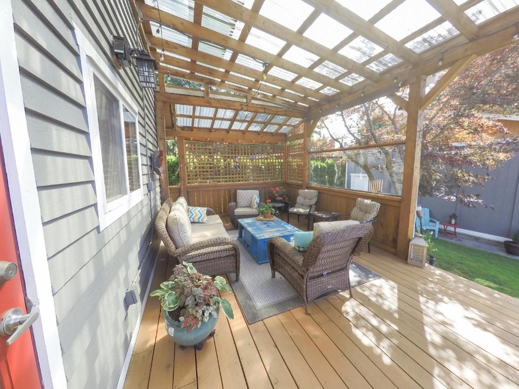 a screened porch with a table and chairs on a deck at Money Pennies Bed and Breakfast in Campbell River