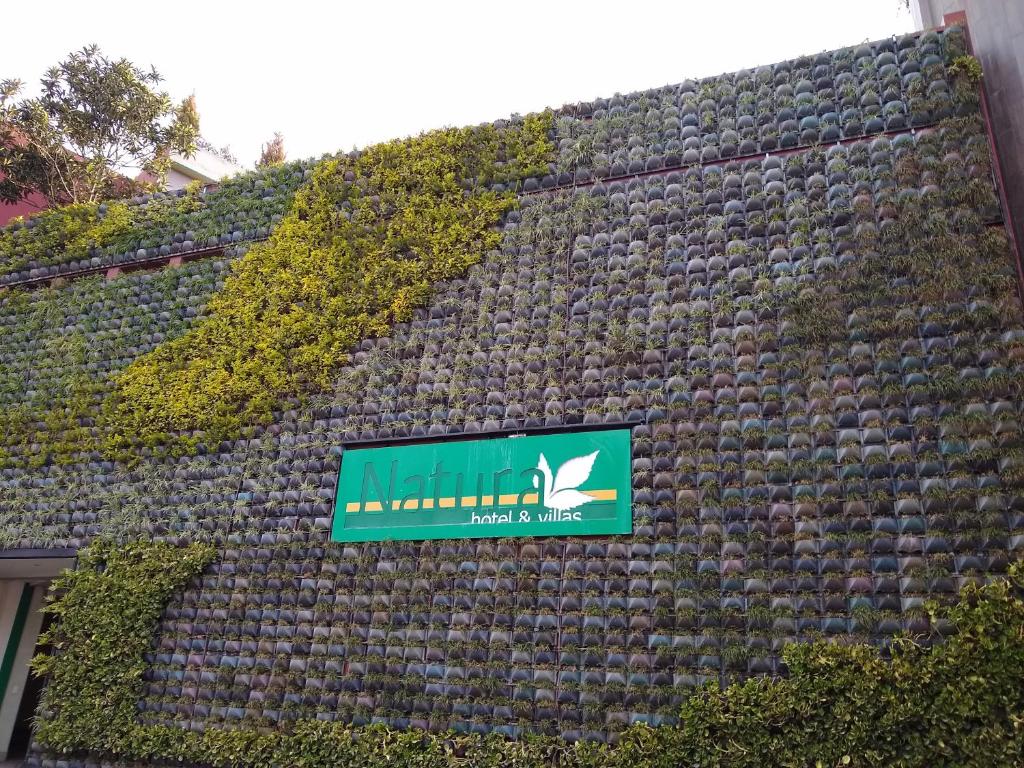 a building with a sign on the side of it at Hotel y Villas Natura in Mexico City