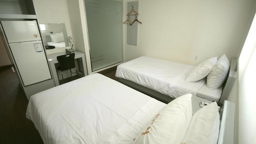 Postel nebo postele na pokoji v ubytování Residence Mumum Hotel