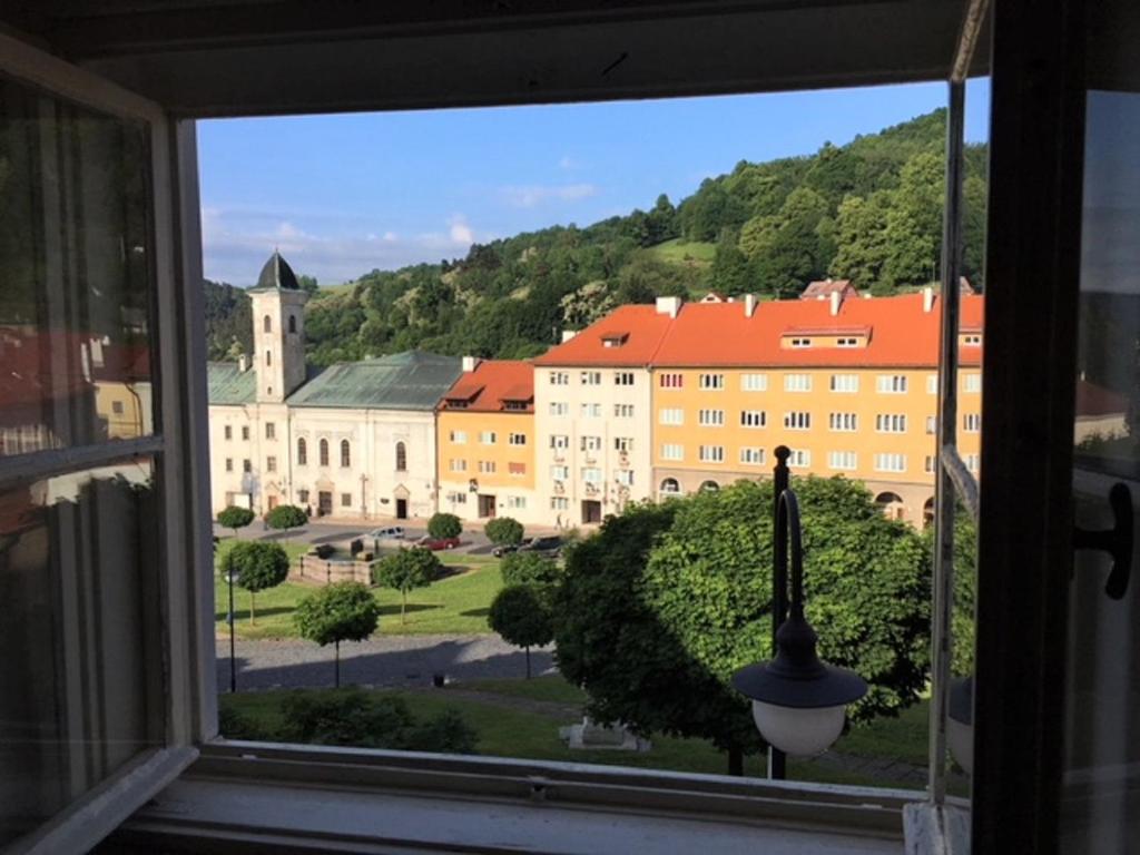 a view of a building from a window at Apartmán s výhľadom in Kremnica