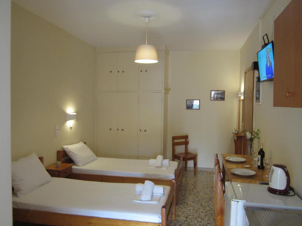 a small room with two beds and a television at Dimitra appartements in Argostoli
