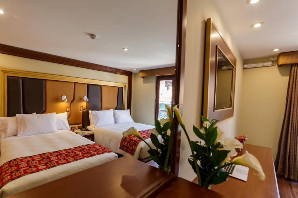 Cama o camas de una habitación en Yawar Inka Hotel
