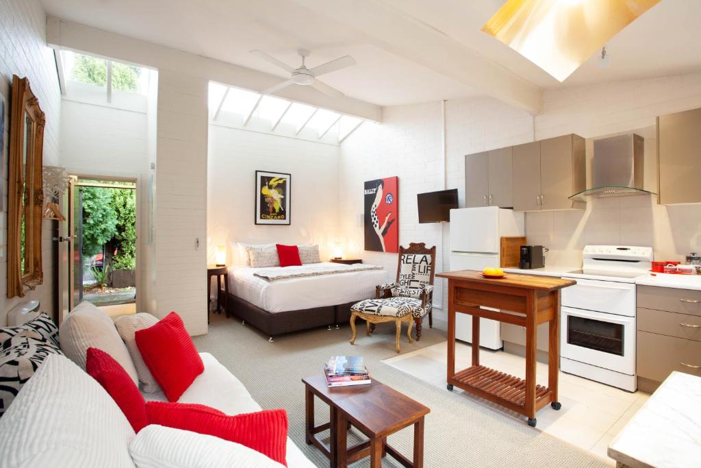 a kitchen and living room with a couch and a table at Apartments on Elsmere in Launceston