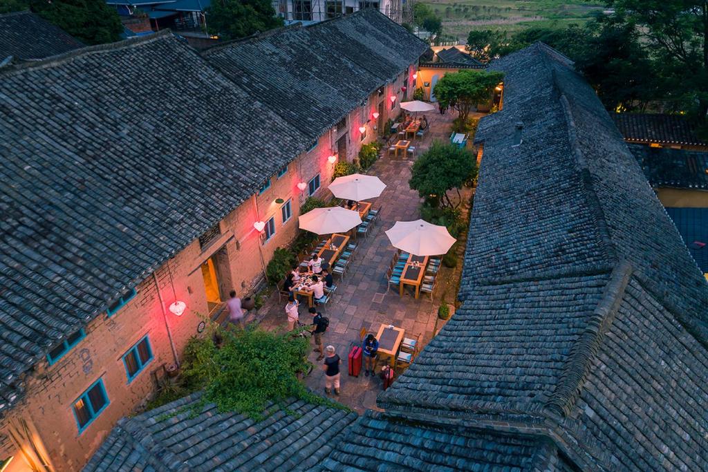 an overhead view of a patio with tables and umbrellas at The Giggling Tree in Yangshuo