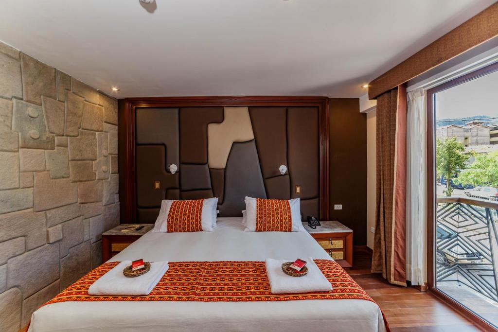Cama o camas de una habitación en Yawar Inka Hotel