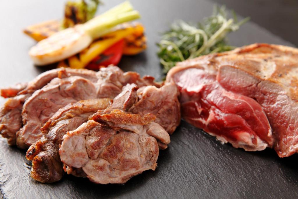a close up of meat and vegetables on a table at Grand Prince Hotel Shin Takanawa in Tokyo