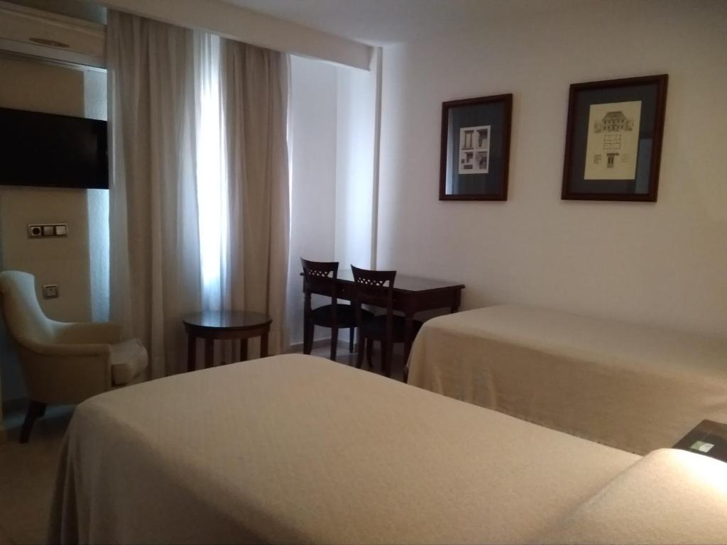 Posteľ alebo postele v izbe v ubytovaní Hotel Nuevo Ara
