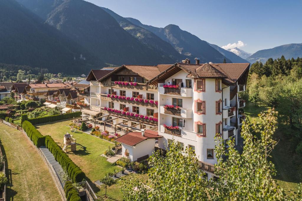 an aerial view of a hotel with mountains in the background at Aparthotel Panorama in Gais