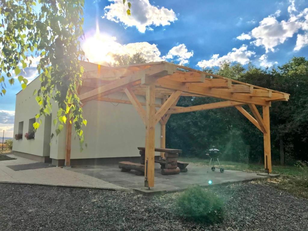 a wooden pavilion with a grill in a yard at MiniPenzion Na Vyhlídce in Olomouc