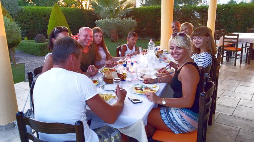 a group of people sitting at a table eating at Eleart in Golem