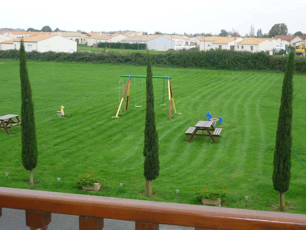 a park with a picnic table and a playground at Chambres d&#39;Hôtes Mazurier in Cozes