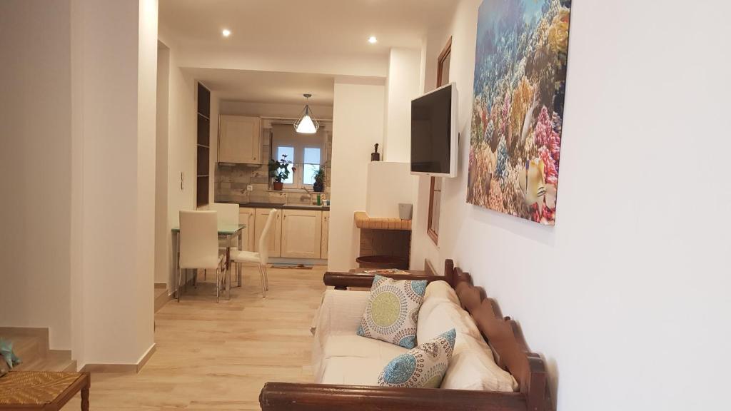 a living room with a couch and a kitchen at Blue Island in Batsi