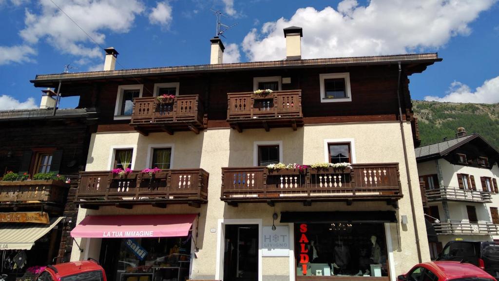 ein großes Gebäude mit Balkonen und Blumen darauf in der Unterkunft Appartamento Jek in Livigno
