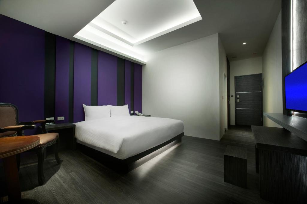 Postel nebo postele na pokoji v ubytování Two Fukun Hotel