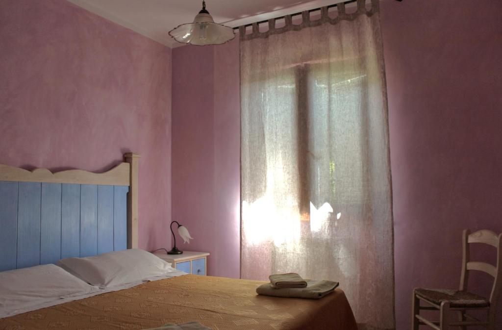 Postel nebo postele na pokoji v ubytování Agriturismo Roccagelli