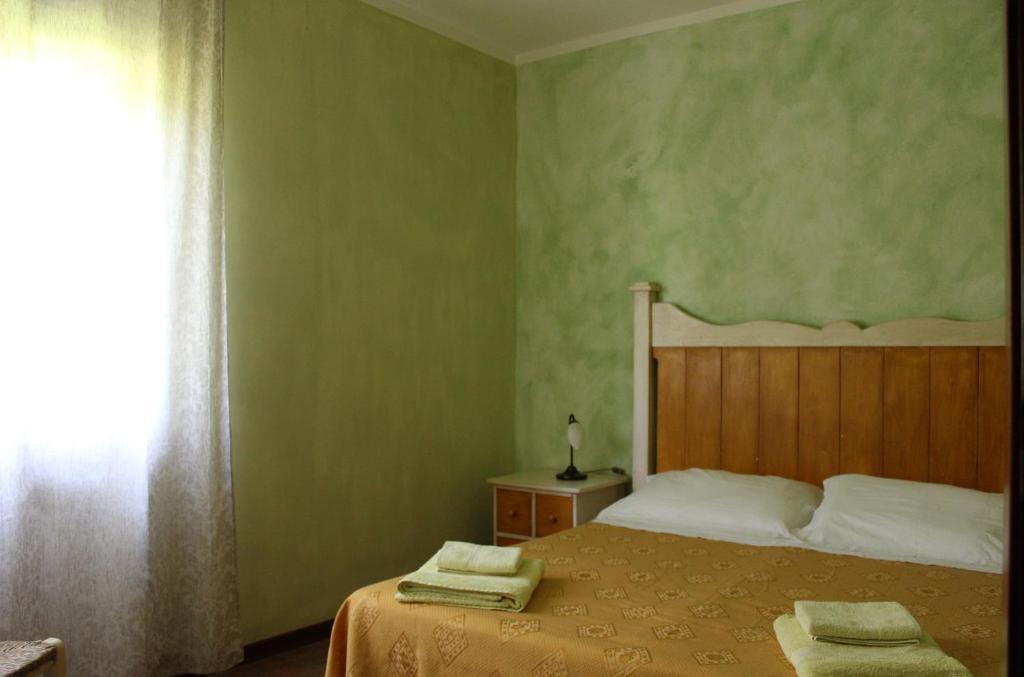 Postel nebo postele na pokoji v ubytování Agriturismo Roccagelli