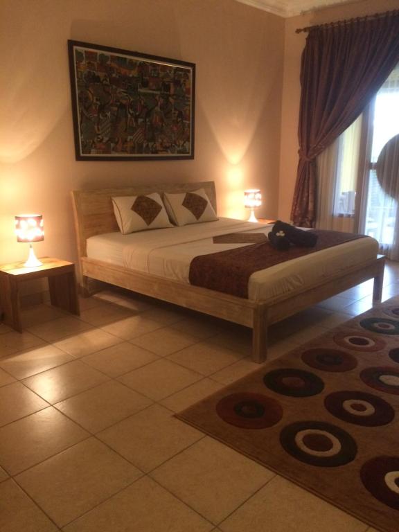 Giường trong phòng chung tại Ada Waktu Homestay