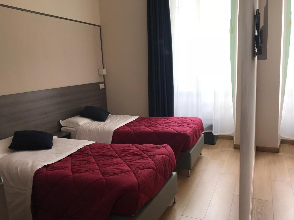 Postel nebo postele na pokoji v ubytování Boutique Hôtel Neptune Nice