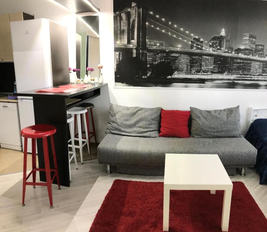a living room with a couch and a table at U Aeroporta Mini-Hotel in Koltsovo
