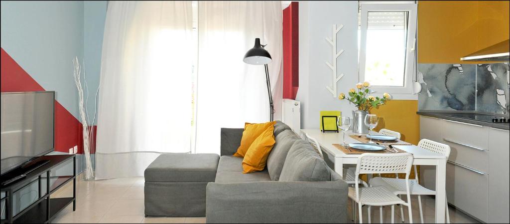 a living room with a couch and a table in a kitchen at Peraia Club Apartments in Perea