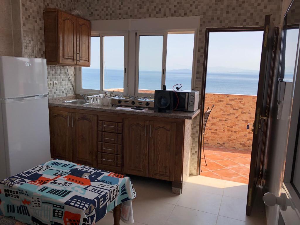 a kitchen with a view of the ocean at Residencial Puro Mediterraneo in Ceuta