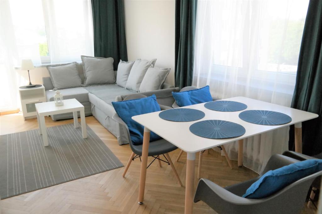グディニャにあるGdynia Kamienna Góraのリビングルーム(白いテーブル、青い椅子付)