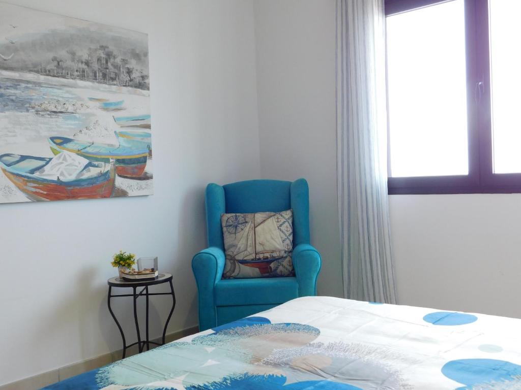 A bed or beds in a room at El Roquito Ocean View