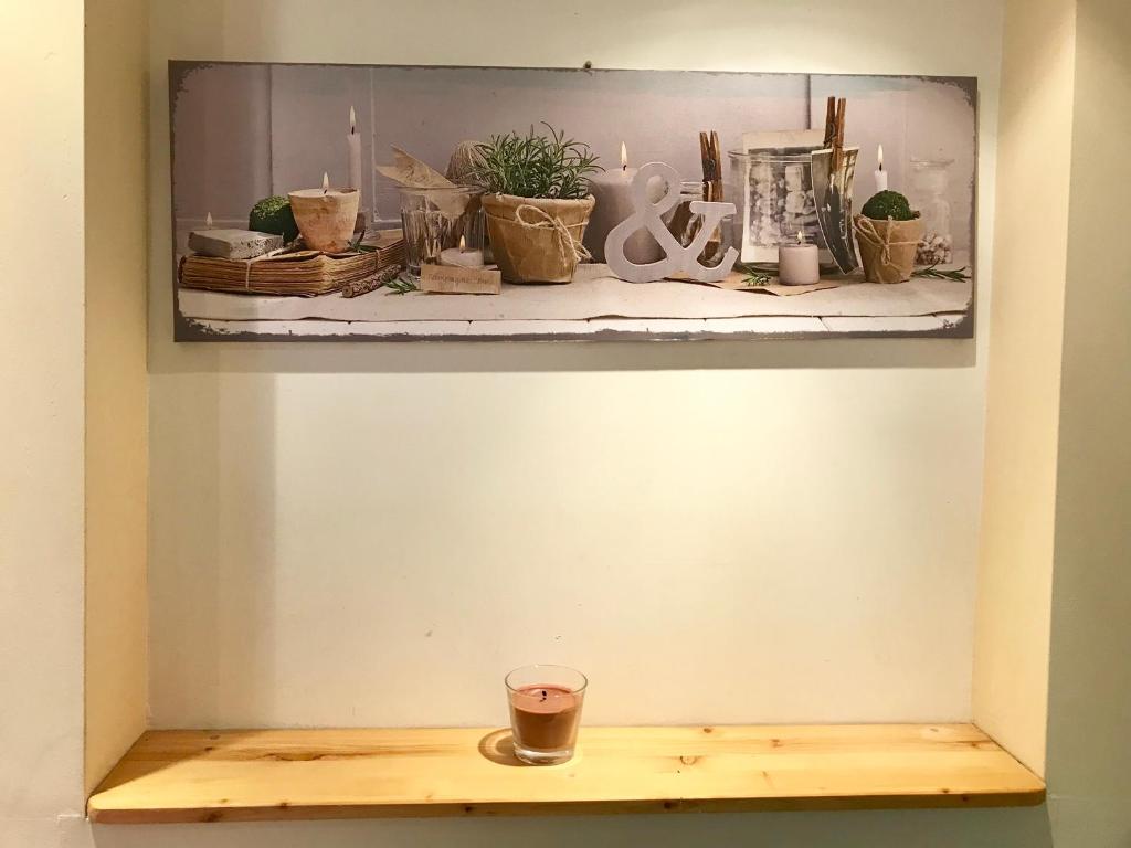 a shelf with plants and a cup on it at Studio Porteille d'Ax in Ax-les-Thermes