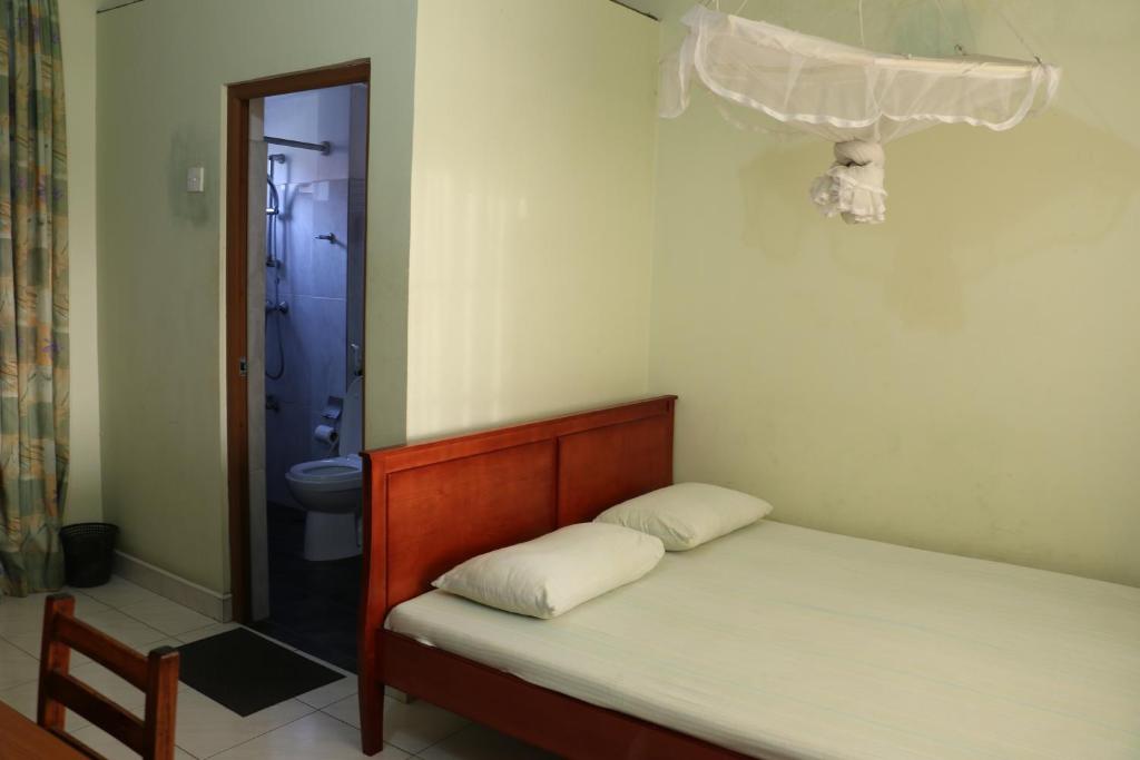 Postel nebo postele na pokoji v ubytování Tamarind Breeze