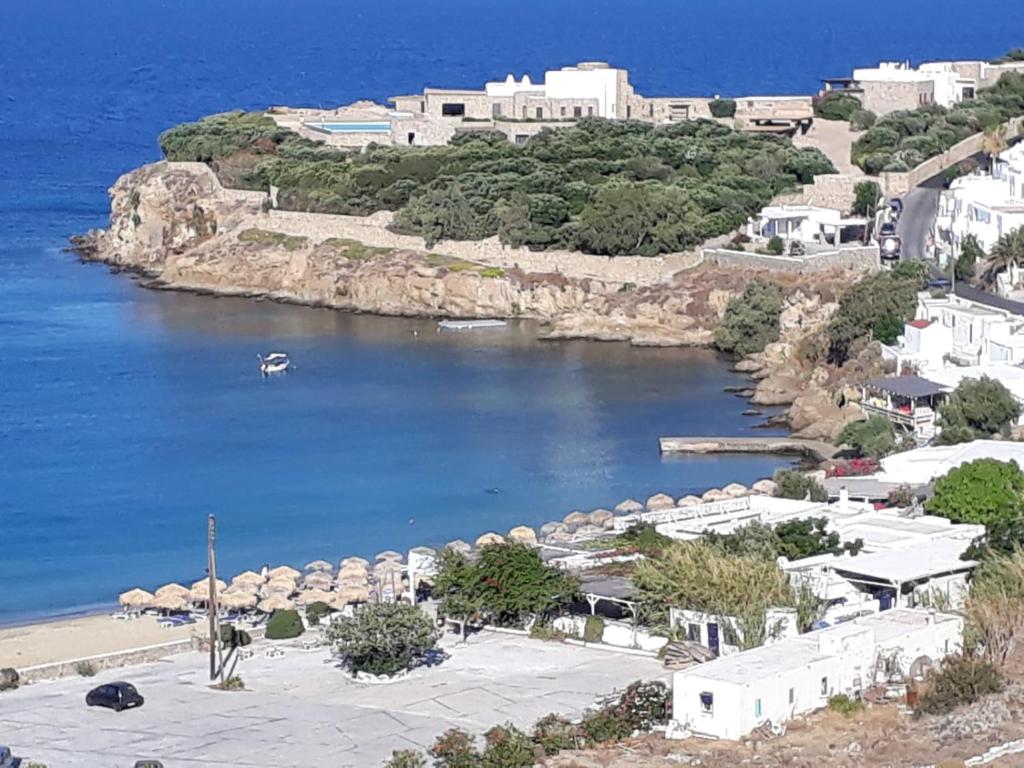 a view of a body of water with a beach at Mykonos Beachfront House with Sunset & Delos View in Agios Stefanos