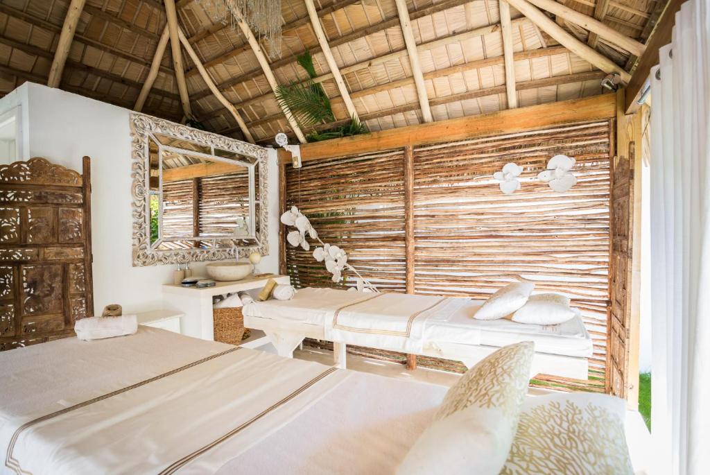 a bedroom with two beds and a window at Mahona Boutique Hotel in Las Terrenas