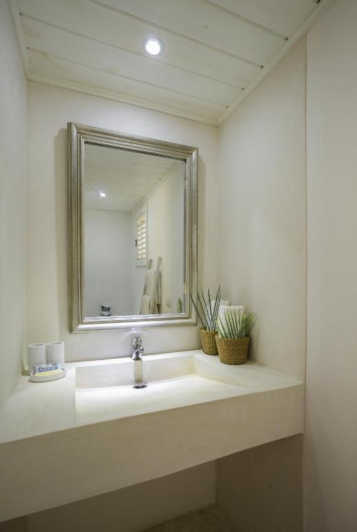 a bathroom with a sink and a mirror at Mahona Boutique Hotel in Las Terrenas