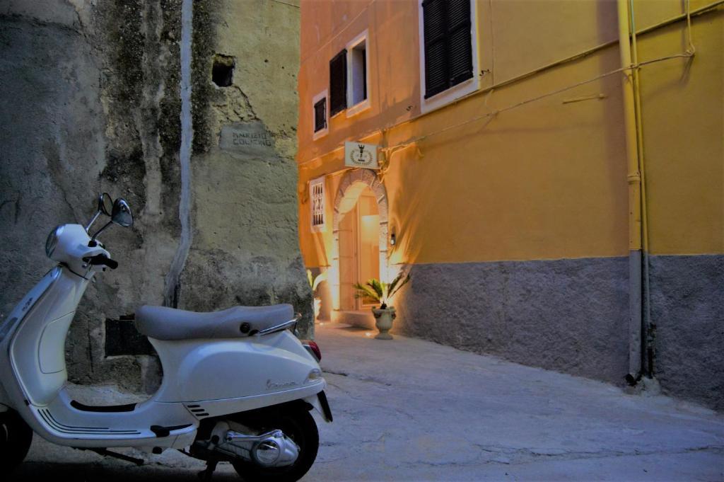 a scooter parked in an alley next to a building at B&B The Tower in Tropea