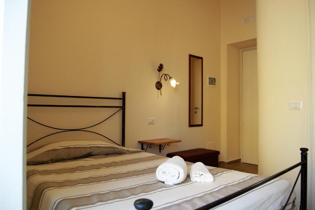 a bedroom with a bed with towels on it at B&B The Tower in Tropea