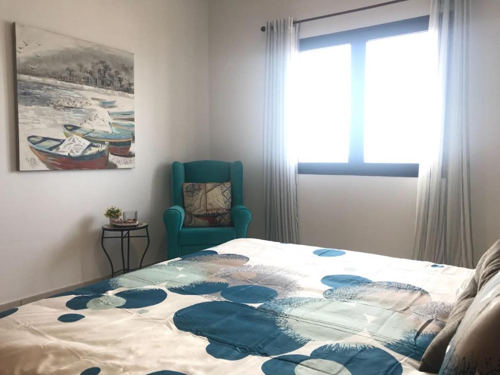 A bed or beds in a room at El Roquito Ocean View