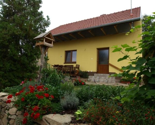 a small yellow house with a garden and flowers at Ing. Martin Čech Kielar in Hlohovec