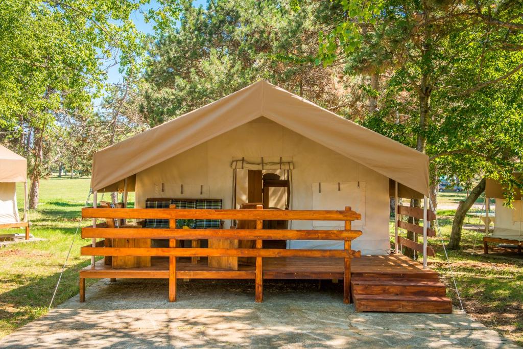 une petite tente avec un banc dans un champ dans l'établissement SunFlower Camping Savudrija, à Savudrija