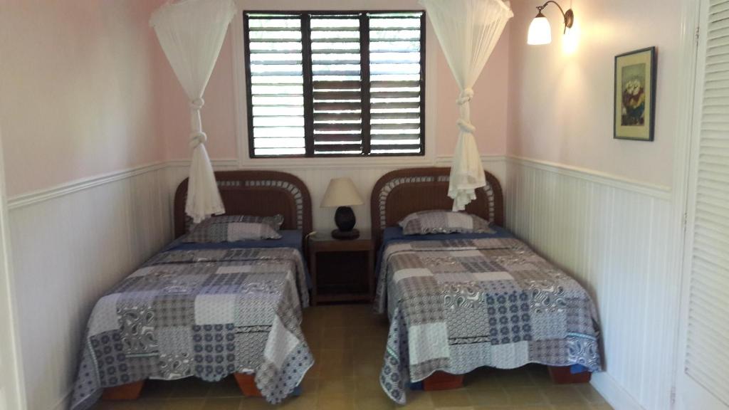 Postel nebo postele na pokoji v ubytování Playa Negra Guesthouse