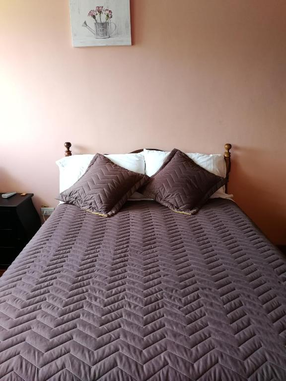 Postel nebo postele na pokoji v ubytování Chapelet Hostal
