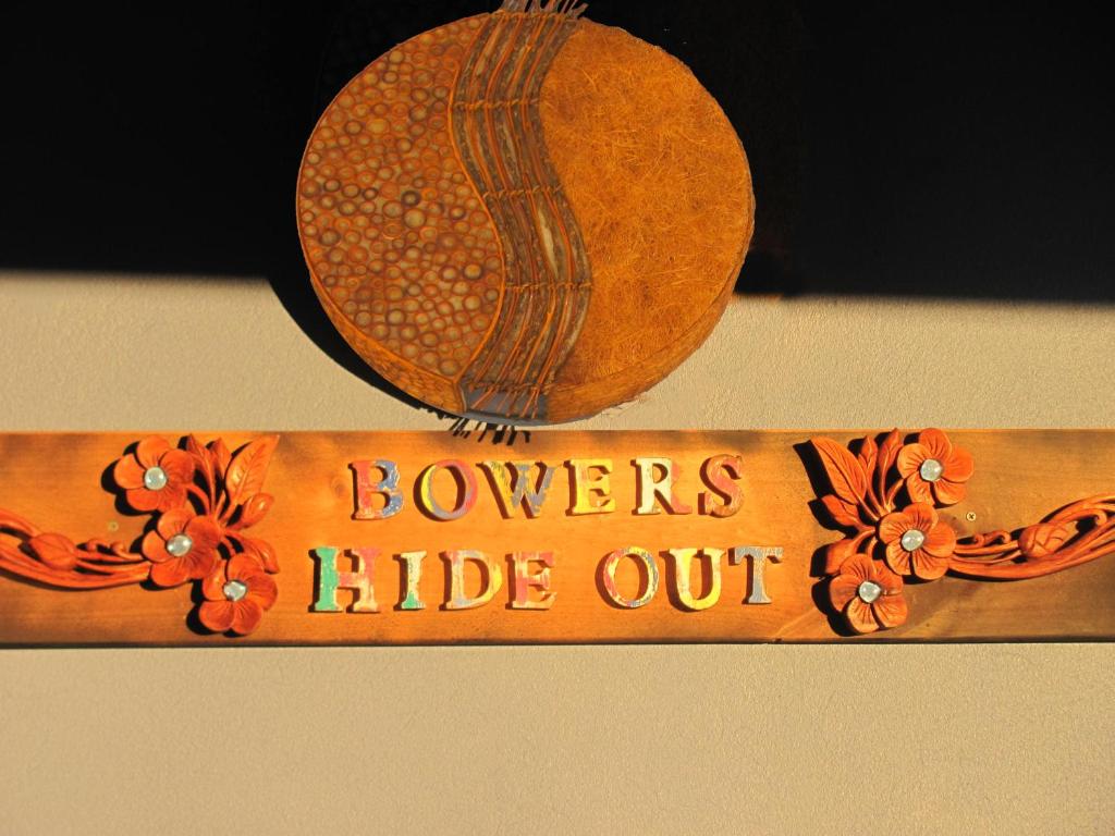 a wooden sign that says lovers hide out at Bower's Hideout in Kandos