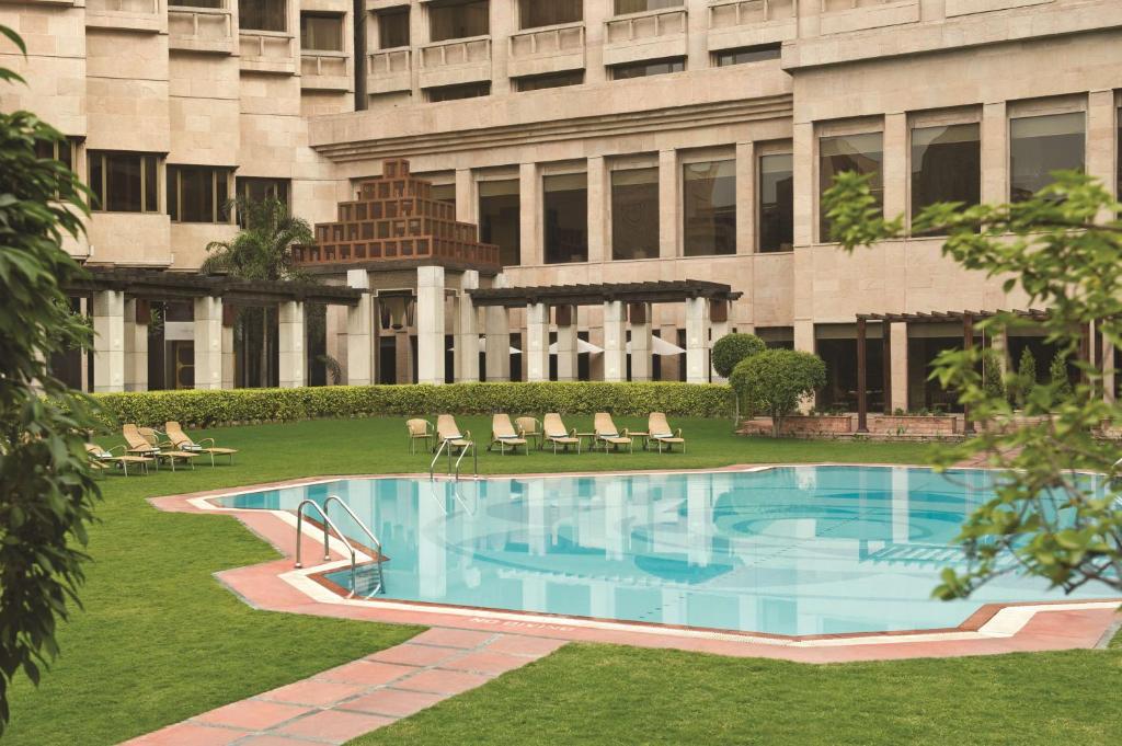 a swimming pool in front of a building at Hyatt Regency Delhi in New Delhi